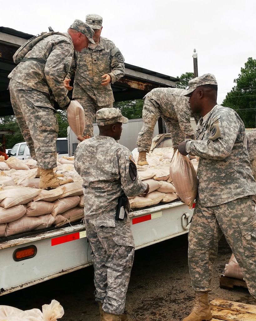 Georgia Army National Guard and Georgia State Defense Force Soldiers work together to load sandbags onto a flatbed truck as part of hurricane relief efforts near Augusta, Georgia. (Georgia State Defense Force photo by Chief Warrant Officer 2 W. Kevin Ward, 1BDE, AS3.)