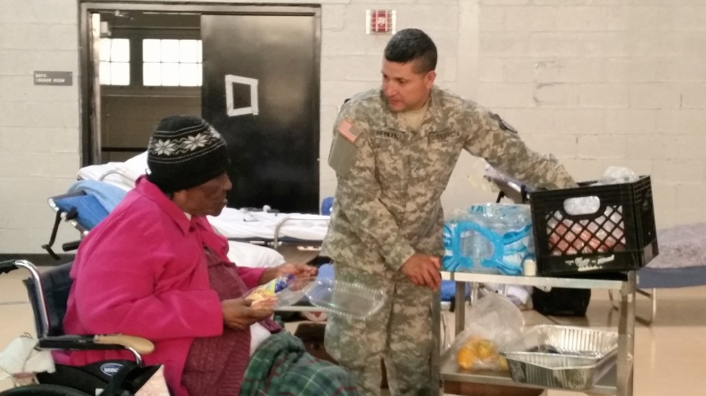 A member of the Georgia State Defense Force provides lunch to an evacuee displaced by Hurricane Matthew at Tubman Education Center in Augusta, Georgia on October 10, 2016. (Georgia State Defense Force photo by Sgt. Ibarra)