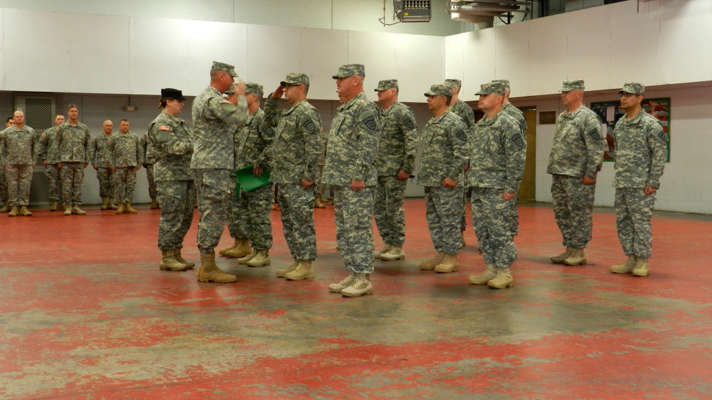 MARIETTA ARMORY, Marietta, Georgia, December 6, 2015 – Capt. Scott Thompson, assisted by Cpl. Melanie Dallas, returns the salute of a Soldier after pinning him with his new rank. (Georgia State Defense Force photo by Pvt. Michael Chapman, Public Affairs Office)