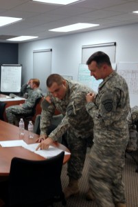 PFC Kerry Hatcher and CPL Howard Seay working in the TOC monitoring operations at Task Force Decatur.
